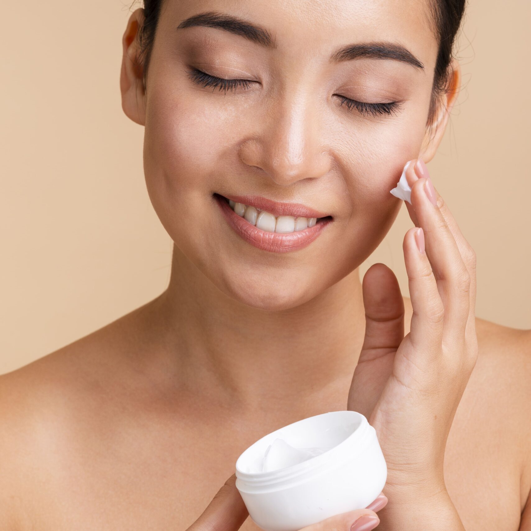 close-up-beautiful-woman-using-face-cream