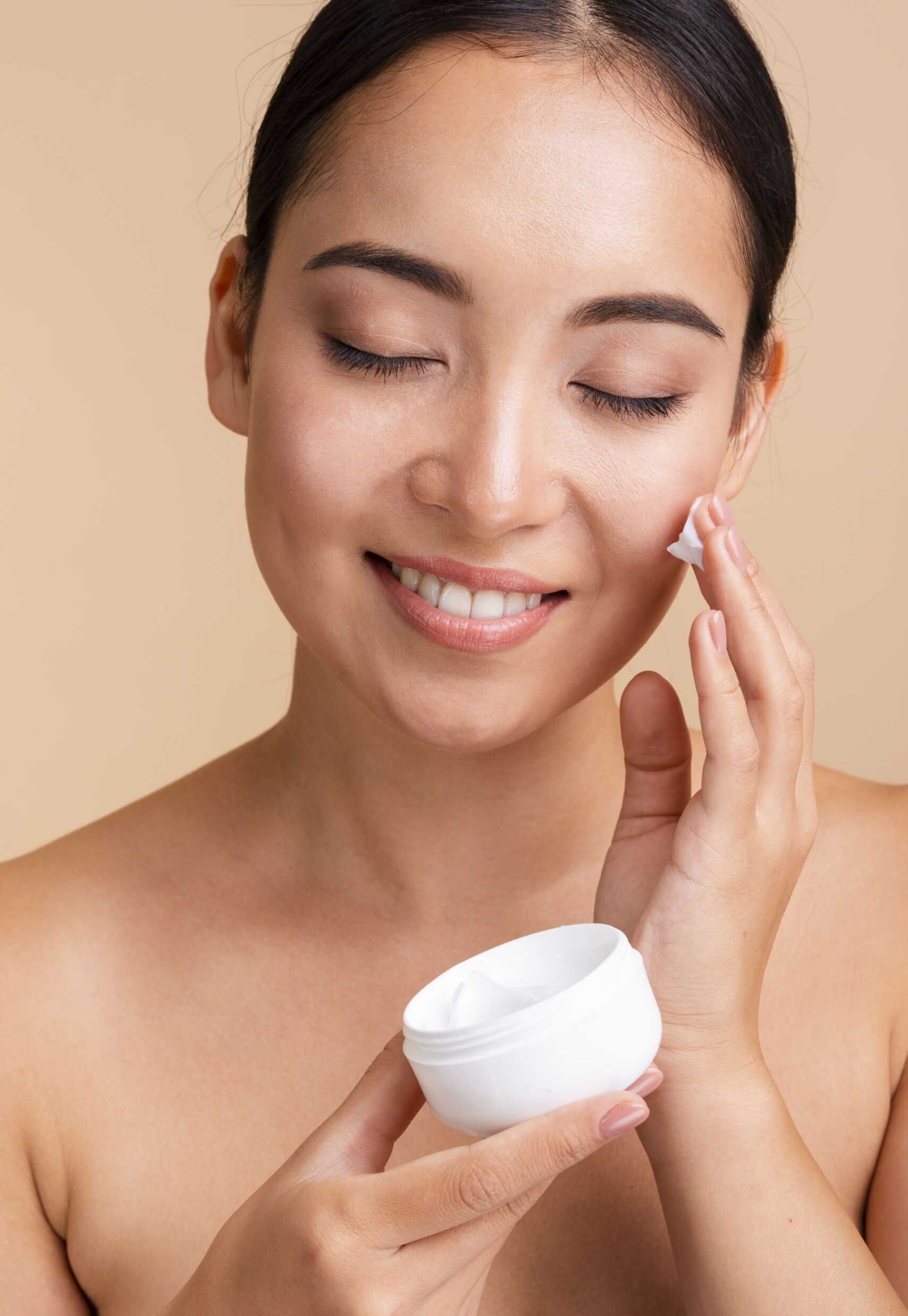 close-up-beautiful-woman-using-face-cream