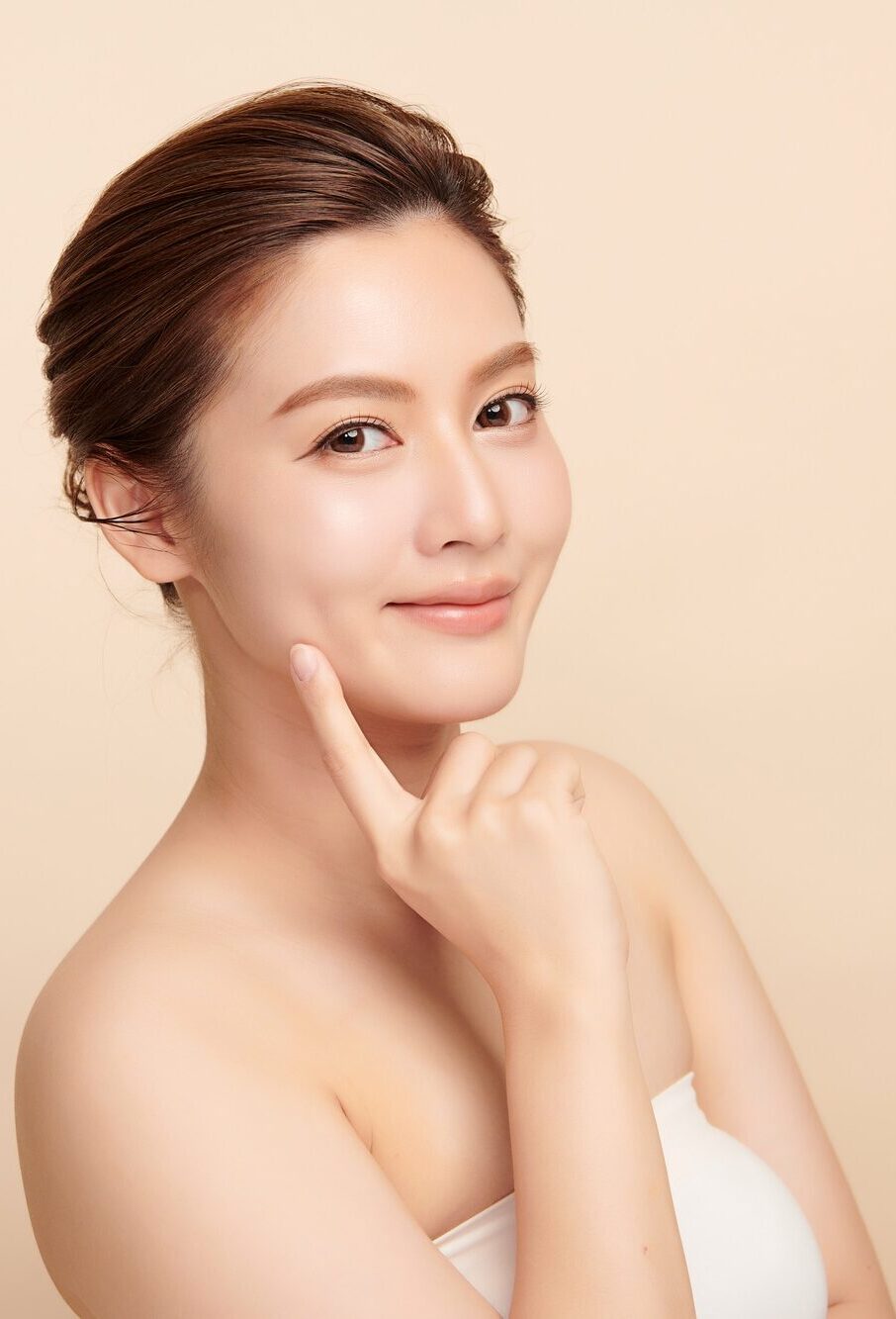 Beautiful young asian woman with clean fresh skin on beige background, Face care, Facial treatment, Cosmetology, beauty and spa, Asian women portrait.