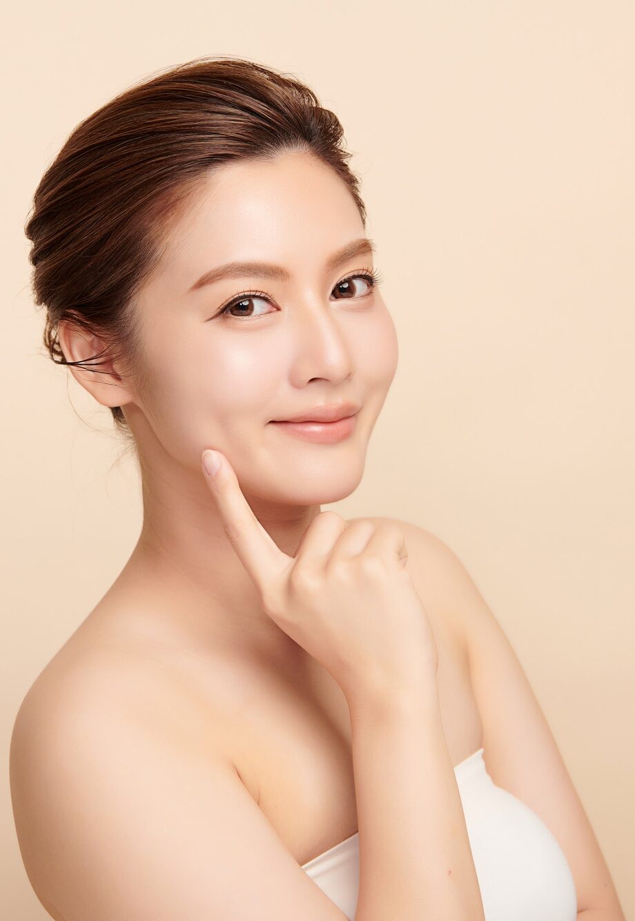 Beautiful young asian woman with clean fresh skin on beige background, Face care, Facial treatment, Cosmetology, beauty and spa, Asian women portrait.